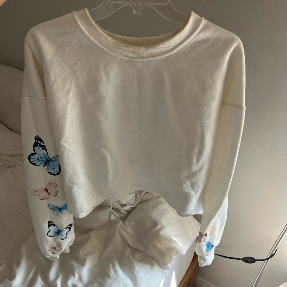 White crewneck with butterfly design and open hem, women’s size M